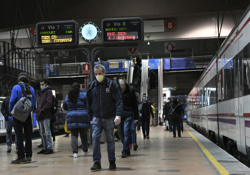 Travelers on the commuter rail platforms at Atocha station.